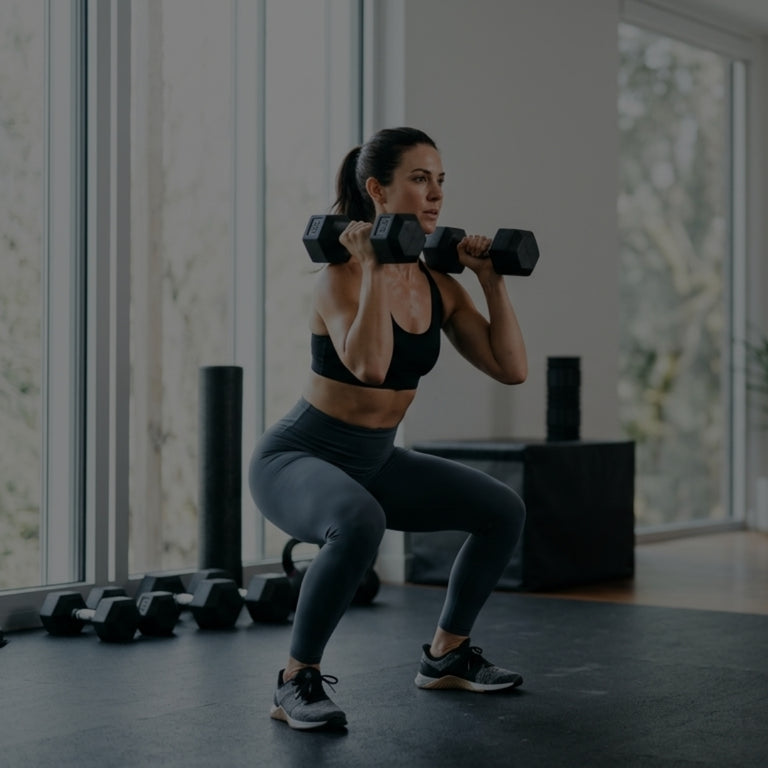 Woman exercising with dumbbells in a modern indoor setting